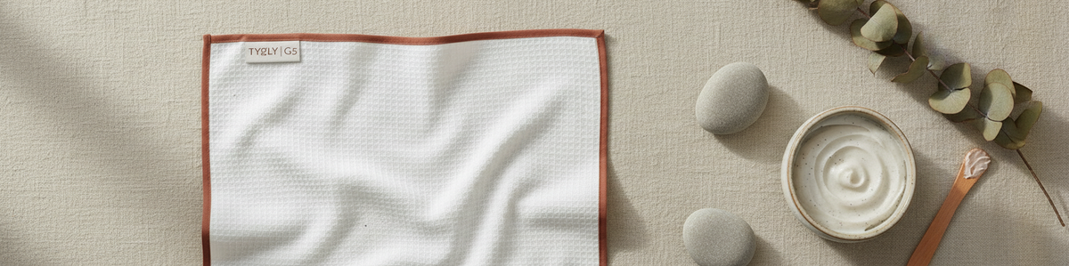 TYGLY Grade 5 dobby waffle face cloth in bathroom flat lay with skincare products